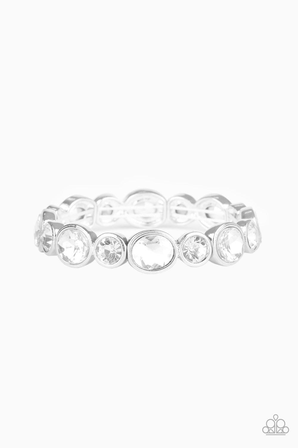 Paparazzi Accessories Still GLOWING Strong - White Encased in sleek silver frames, oval and round white rhinestones alternate along a stretchy band around the wrist for a timeless look. Sold as one individual bracelet. Jewelry
