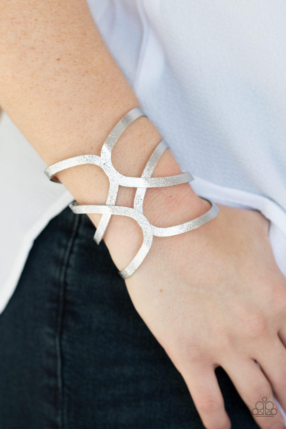 Paparazzi Accessories Crossing The Finish Line - Silver Delicately hammered in endless shimmer, glistening silver bars crisscross across the wrist, coalescing into a bold cuff. Jewelry