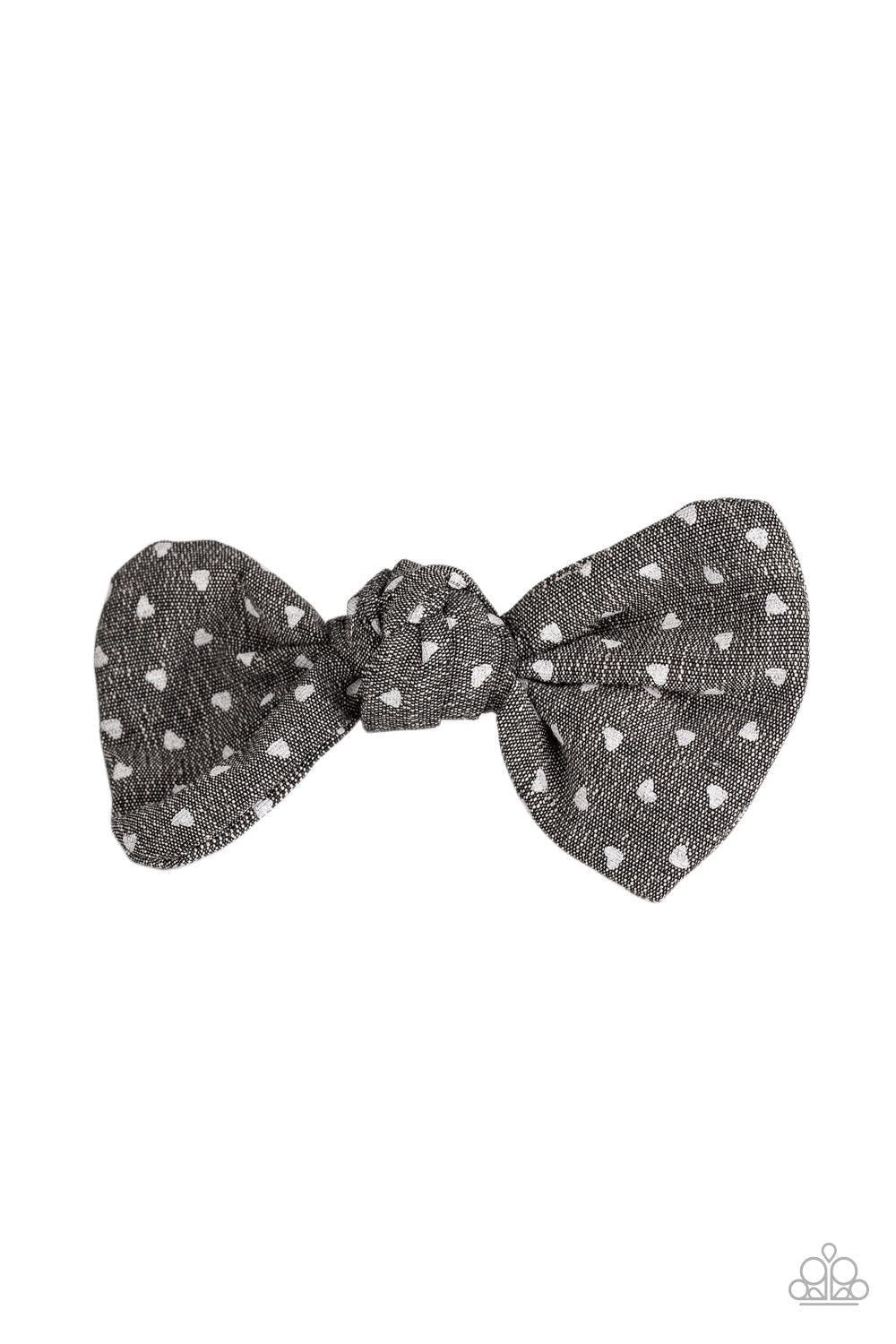 Paparazzi Accessories Bow A Kiss - Black Sprinkled in dainty hearts, black fabric delicately knots into a flirty bow. Features a standard hair clip on the back. Hair Accessories