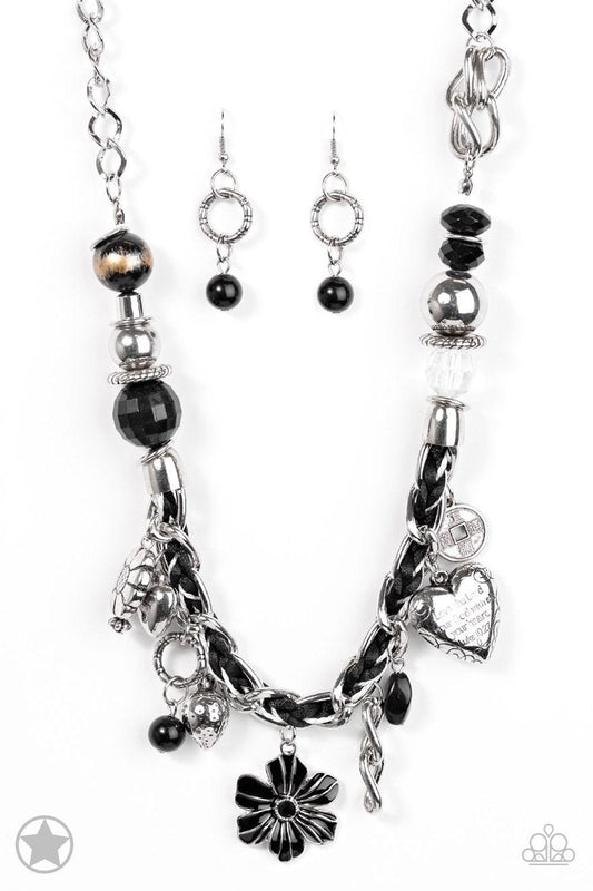 Paparazzi Accessories Charmed I Am Sure - Black Black and ivory cording is braided through a chunky silver chain. A unique variety of charms decorate the piece including a delicate flower and a heart. Heart is inscribed with the phrase "With All My Heart"