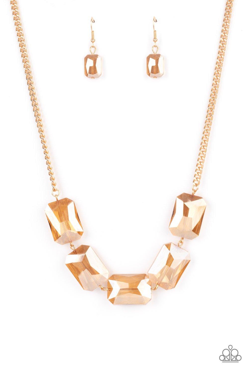Paparazzi Accessories Heard It On The Heir-Waves ~Gold Gorgeously oversized golden emerald cut gems fabulously link below the collar, creating an iridescently icy statement piece. Features an adjustable clasp closure. Sold as one individual necklace. Incl