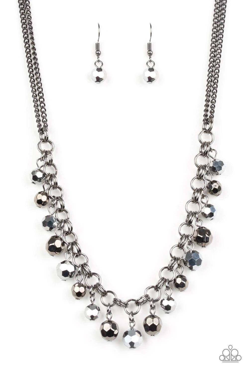 Paparazzi Accessories And The Crowd Cheers - Black A collection of faceted gunmetal and hematite beads swing from the bottom of a double-link gunmetal chain, creating a blinding fringe below the collar. Features an adjustable clasp closure. Sold as one in