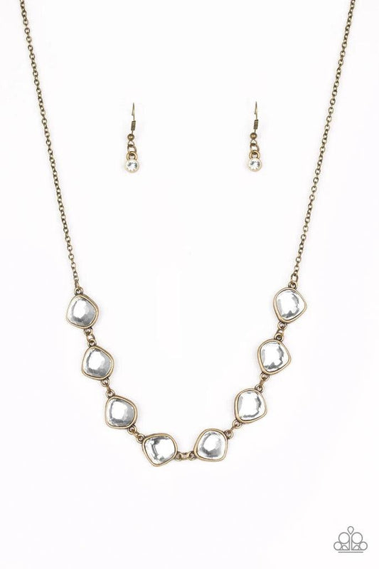 Paparazzi Accessories The Imperfectionist - Brass Featuring antiqued brass frames, imperfect glassy white gems link below the collar for a glamorous vintage inspired look. Features an adjustable clasp closure. Sold as one individual necklace. Includes one