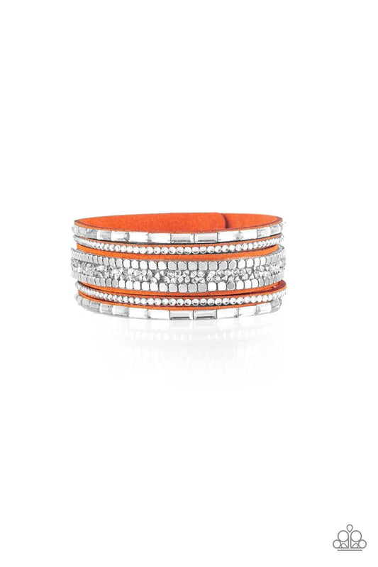 Paparazzi Accessories Rebel In Rhinestones - Orange Featuring round and emerald style cuts, glassy white rhinestones join flat silver cubes and metallic prism rhinestones along an orange suede band for a sassy look. Features an adjustable snap closure. So