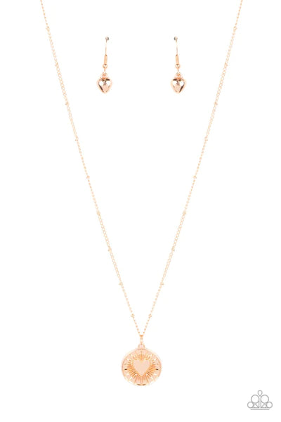 Paparazzi Accessories Lovestruck Shimmer - Gold Embossed with a dainty heart, a gold pendant bursts from the center of a dainty gold satellite chain below the collar for a romantic flair. Features an adjustable clasp closure.