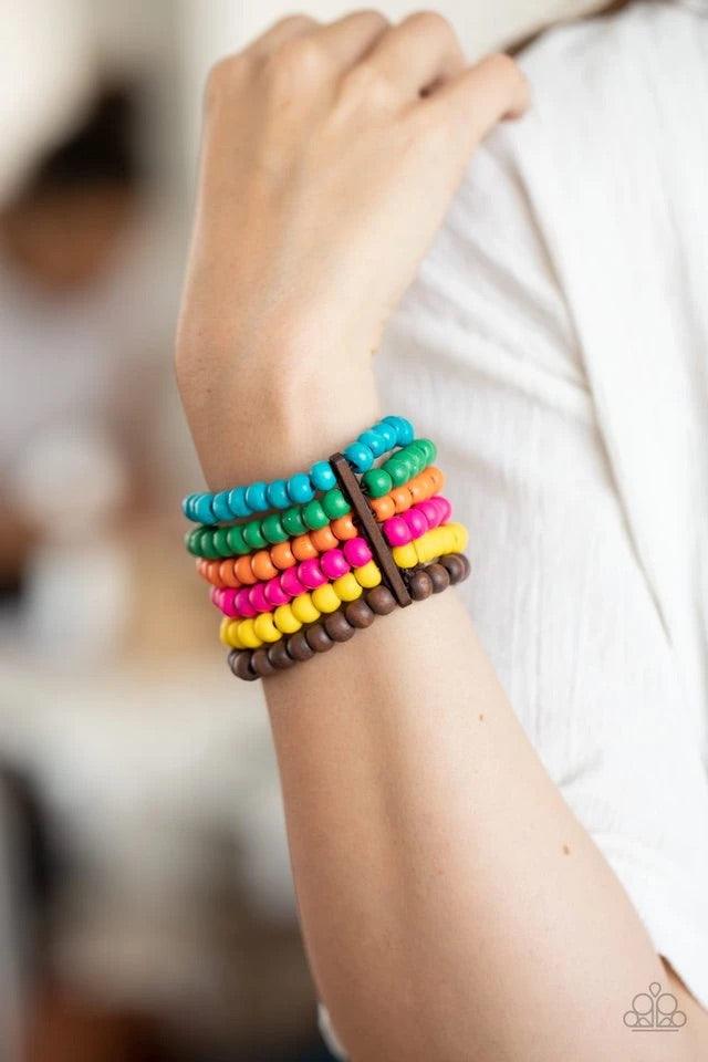 Paparazzi Accessories Diving in Maldives - Multi Held in place with rectangular wooden fittings, a collection of vivacious pink, blue, orange, green, yellow, and brown wooden beads are threaded along stretchy bands around the wrist, creating colorful laye