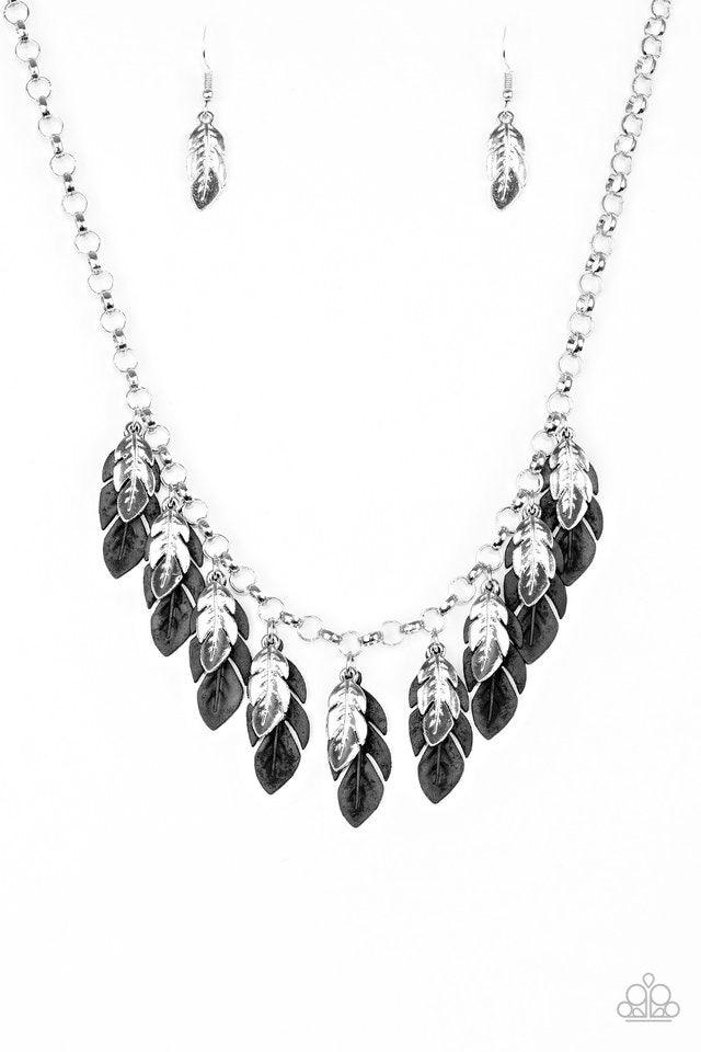 Paparazzi Accessories Rule The Roost - Black Glistening silver and shiny black feathers swing from the bottom of a bold silver chain, creating a fierce fringe below the collar. Features an adjustable clasp closure. Sold as one individual necklace. Include