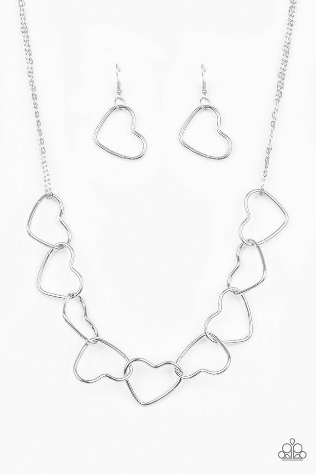 Paparazzi Accessories Unbreak My Heart - Silver Airy silver heart silhouettes connect below the collar for a flirtatious look. Features an adjustable clasp closure. Sold as one individual necklace. Includes one pair of matching earrings. Jewelry
