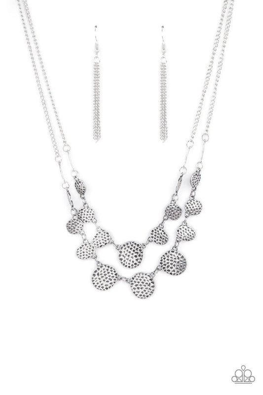 Paparazzi Accessories Pebble Me Pretty - Silver A double row of delicately hammered and dotted silver discs gently lay across the collar. Gradually increasing in size, they connect to silver chains for a simple statement. Features an adjustable clasp clos