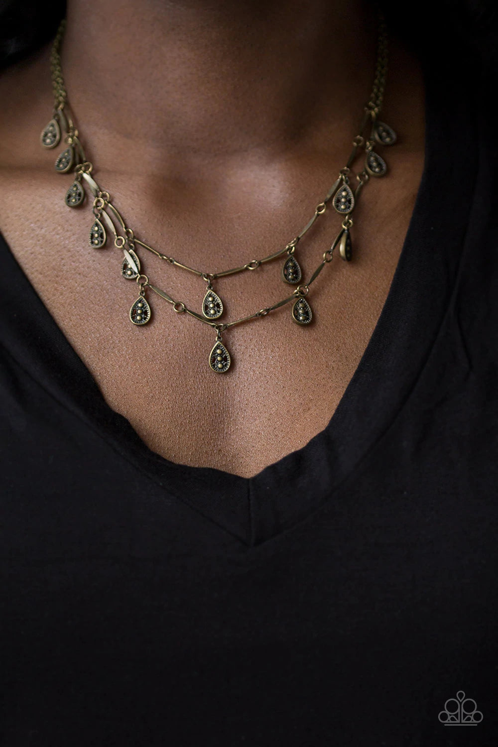 Paparazzi Accessories Galapagos Gypsy - Brass Glistening brass rods and ornate teardrops link below the collar in two rows, creating a playful fringe. Features an adjustable clasp closure. Sold as one individual necklace. Includes one pair of matching ear