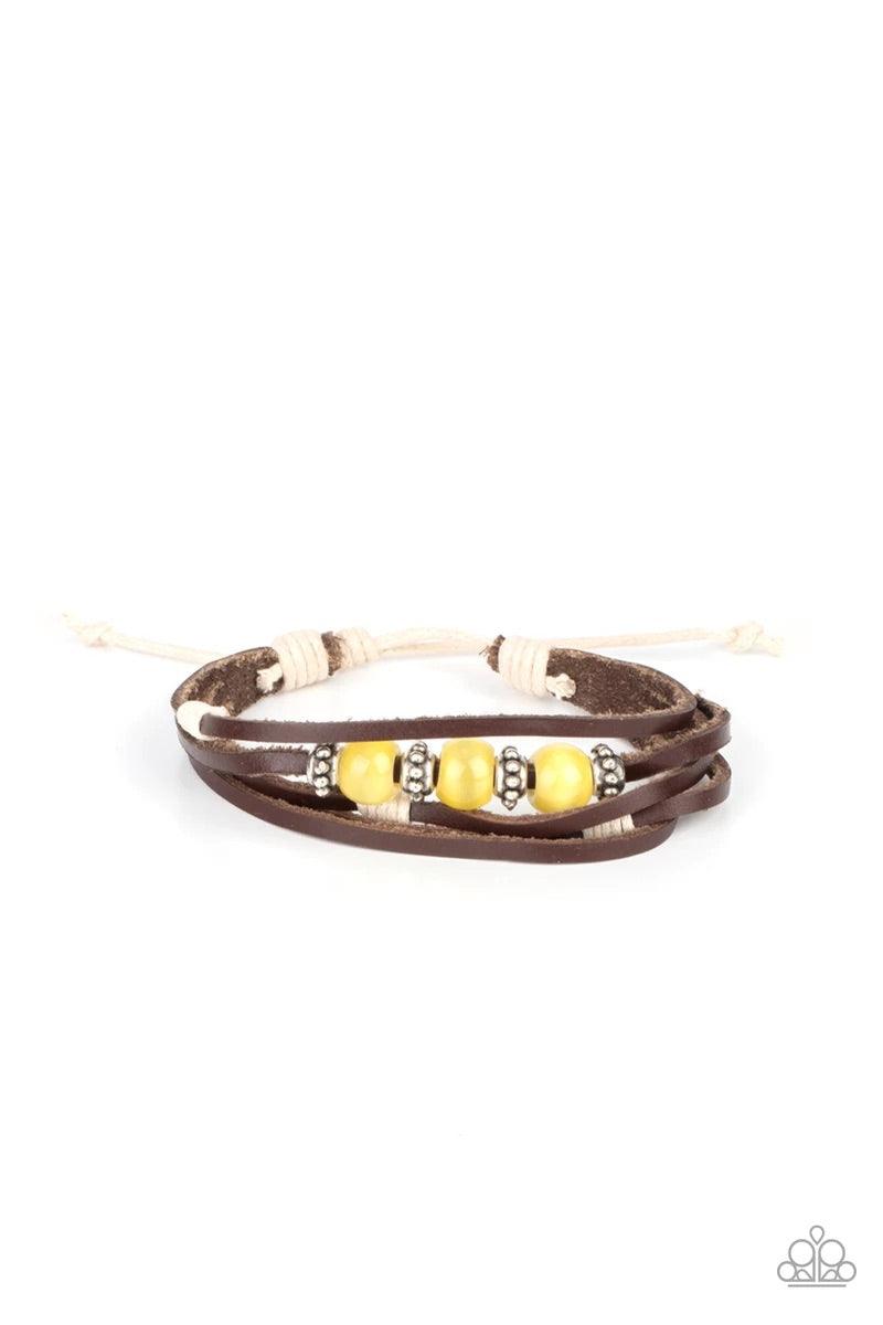 Paparazzi Accessories Homespun Radiance - Yellow Infused with studded silver accents, a row of Illuminating cat's eye stone beads adorn the centermost strand of layered leather bands around the wrist for a colorful seasonal look. Features an adjustable sl