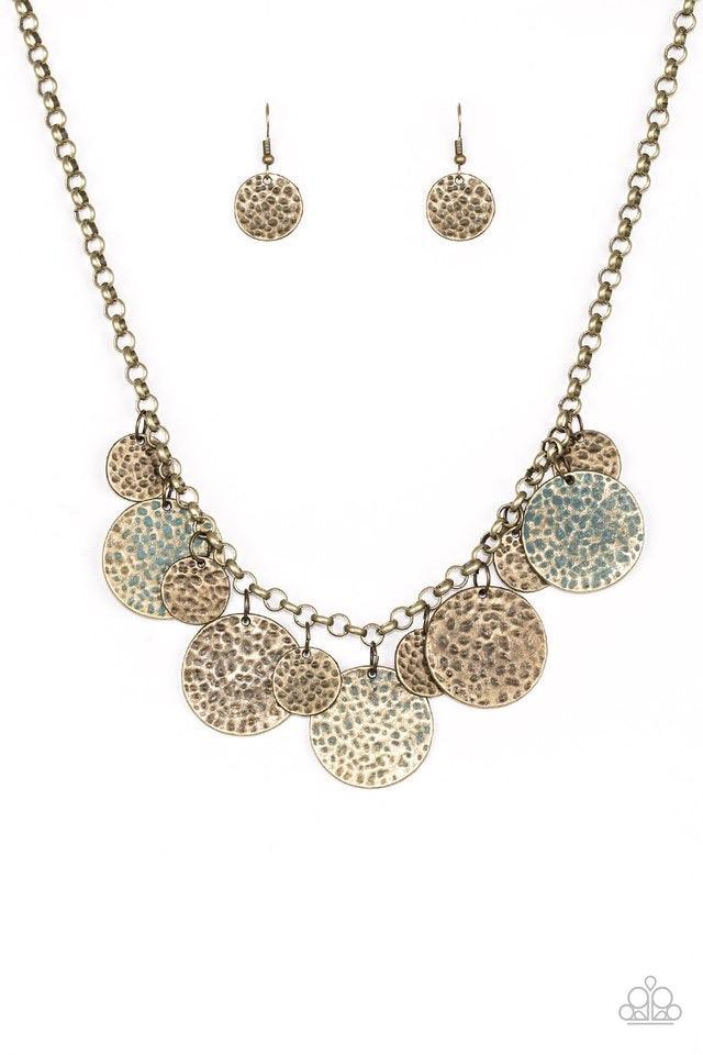 Paparazzi Accessories Treasure HUNTRESS - Brass Delicately hammered in antiqued textures, small and large brass discs alternate below the collar. Three brass discs are brushed in a patina finish for a colorful rustic finish. Features an adjustable clasp c