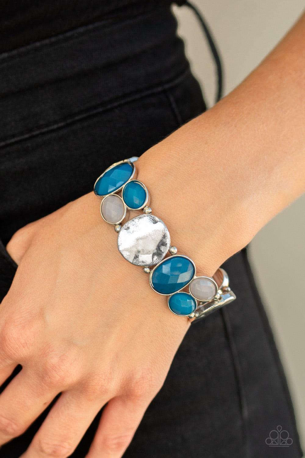 Paparazzi Accessories Chroma Charisma - Blue A mismatched collection of hammered silver pieces and faceted opaque and blue beads are threaded along a stretchy band around the wrist for a dramatically colorful look. Jewelry
